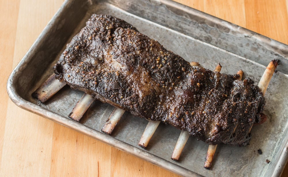 a rack of venison or deer ribs on a baking sheet