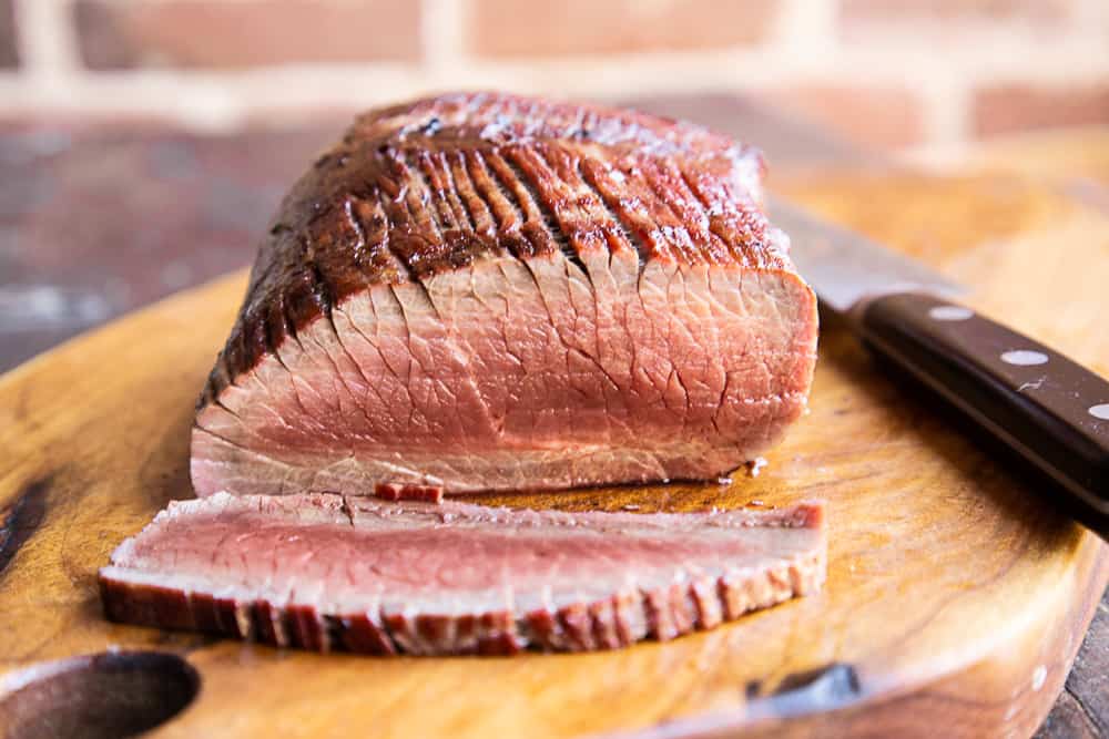 slicing a smoked venison leg roast