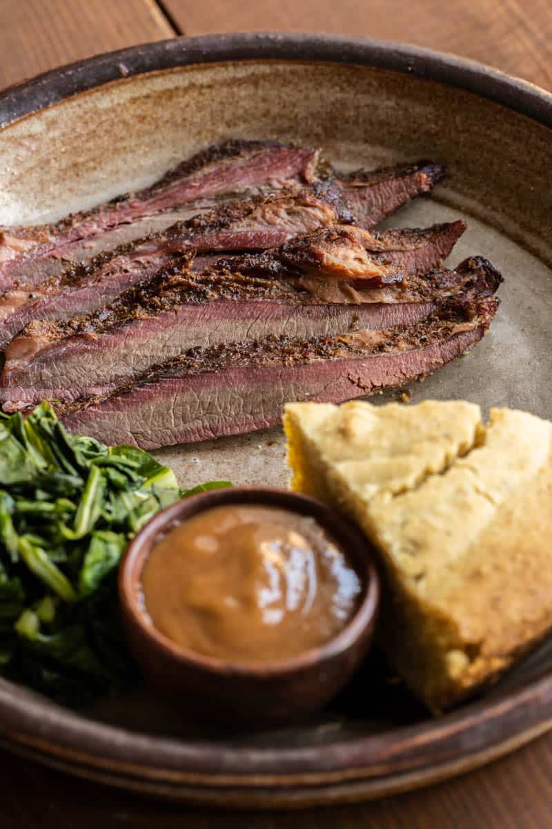 Smoked venison brisket recipe with collard greens and wild plum sauce