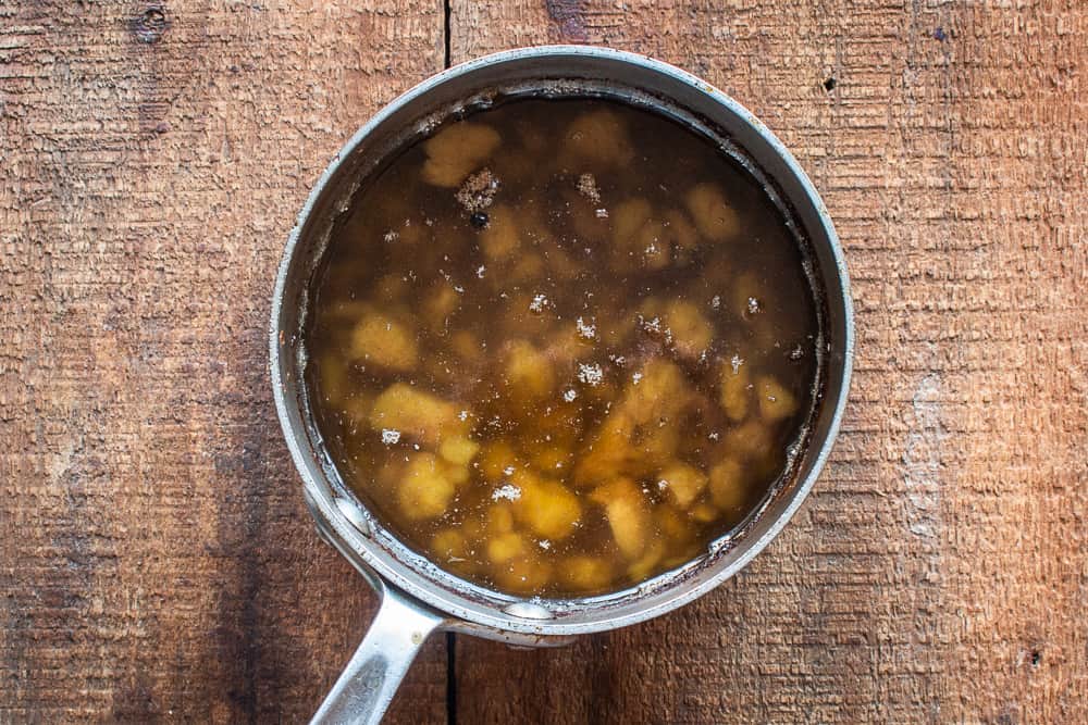 Rendering venison or deer fat with garlic, onions, oil and herbs in a pot