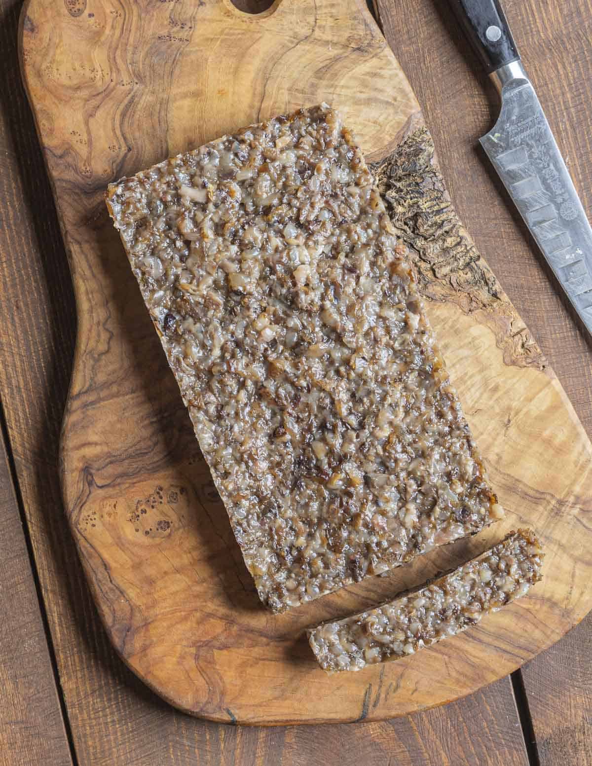Finely chopped venison trotter meat formed and shaped in a mold.