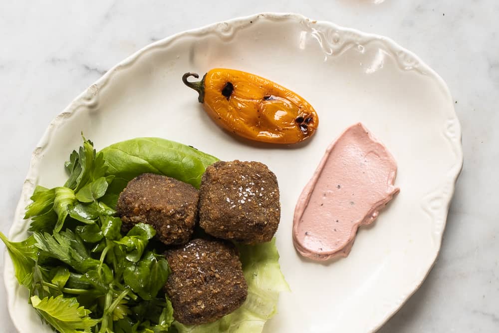 Fried venison trotter cakes with watercress, highbush cranberry aioli, and roasted pepper