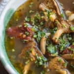 Hedgehog mushroom soup with foraged greens, beans and tomatoes