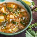 Mallow or malva soup with artichokes and rice