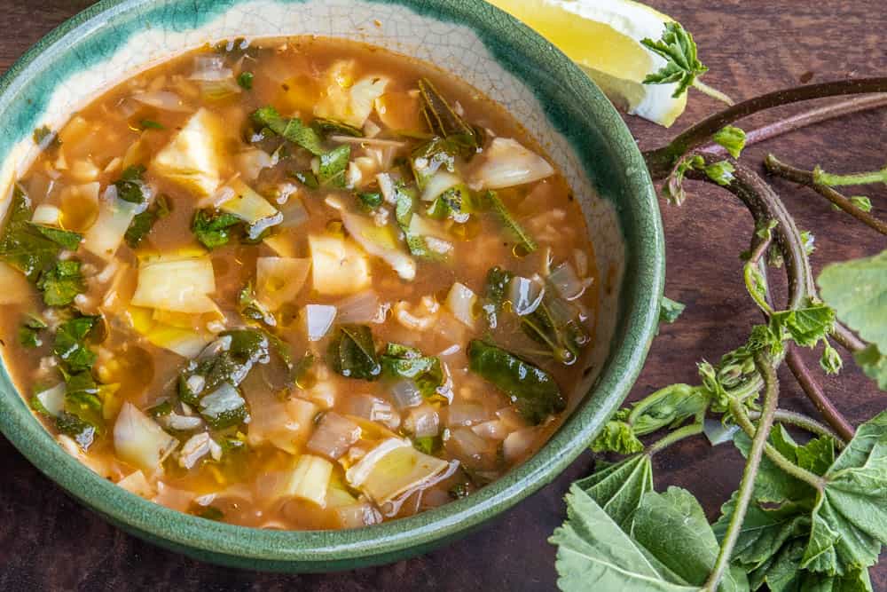 Mallow or malva soup with artichokes and rice