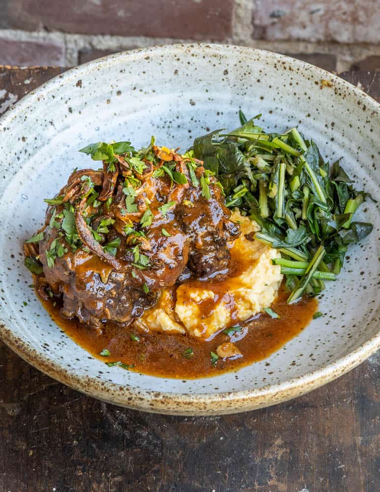 Smoked oxtails stew with polenta and cooked greens 