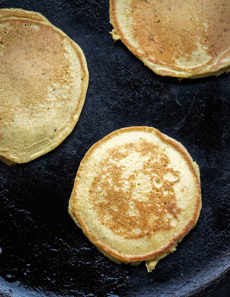 Cooking cattail pollen pancakes in a cast iron pan. 