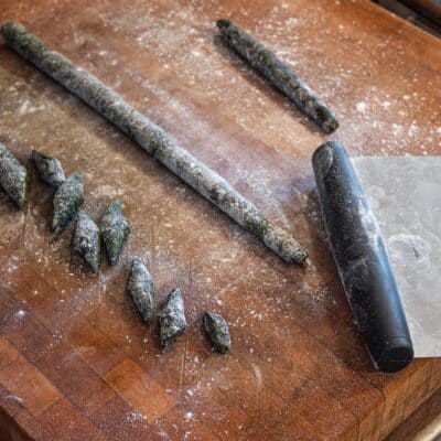cutting green gnocchi with a bench knife