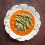 A bowl of nettle gnocchi with tomato sauce and parmesan cheese.