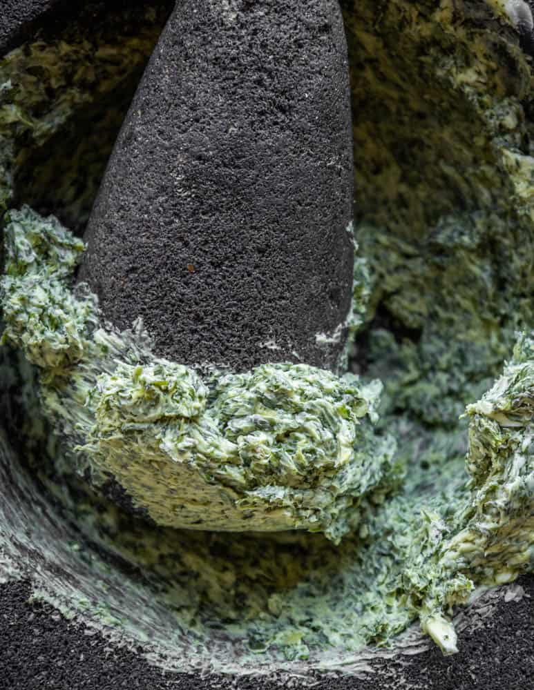 Making wild chervil butter in a mortar and pestle