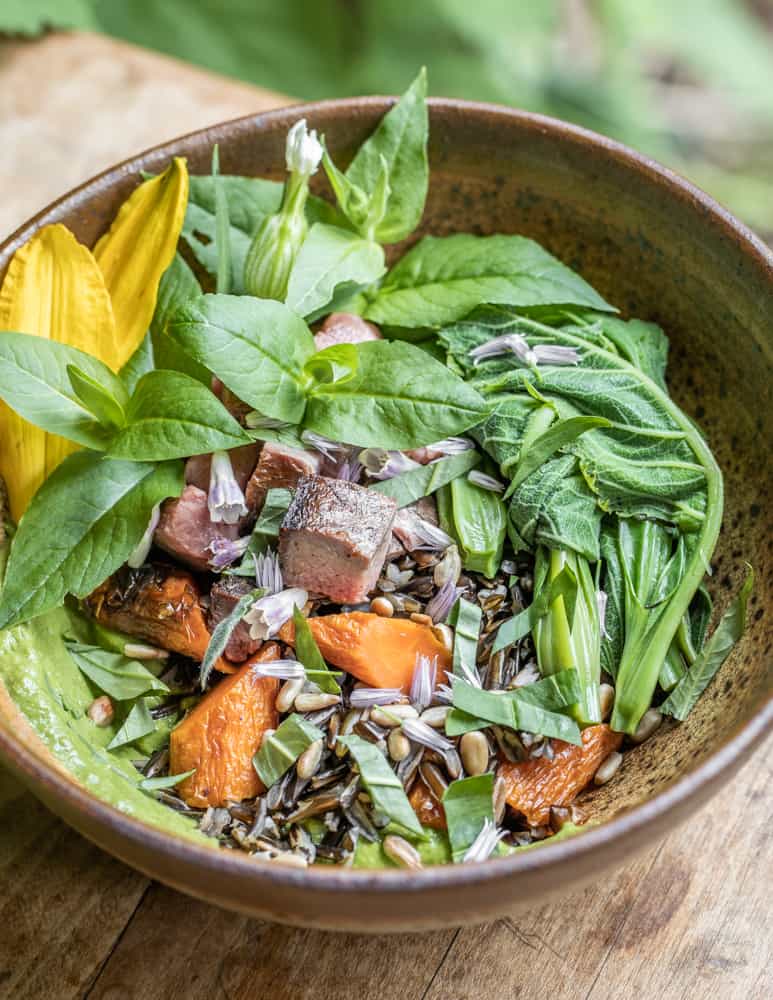 Wild rice bowl with roasted carrots, herbs, sunflower seeds, chickweed, salsa and silphium meristems