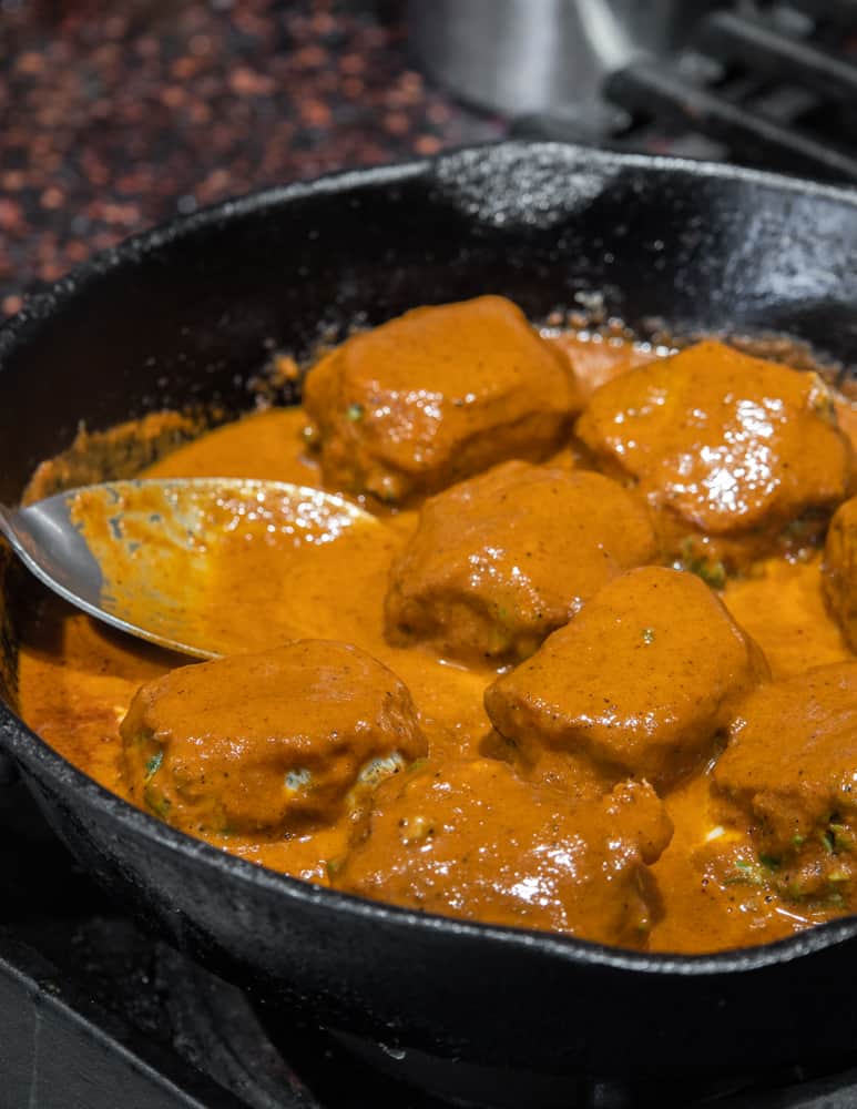 Cooking milkweed bud huazontles in chili sauce