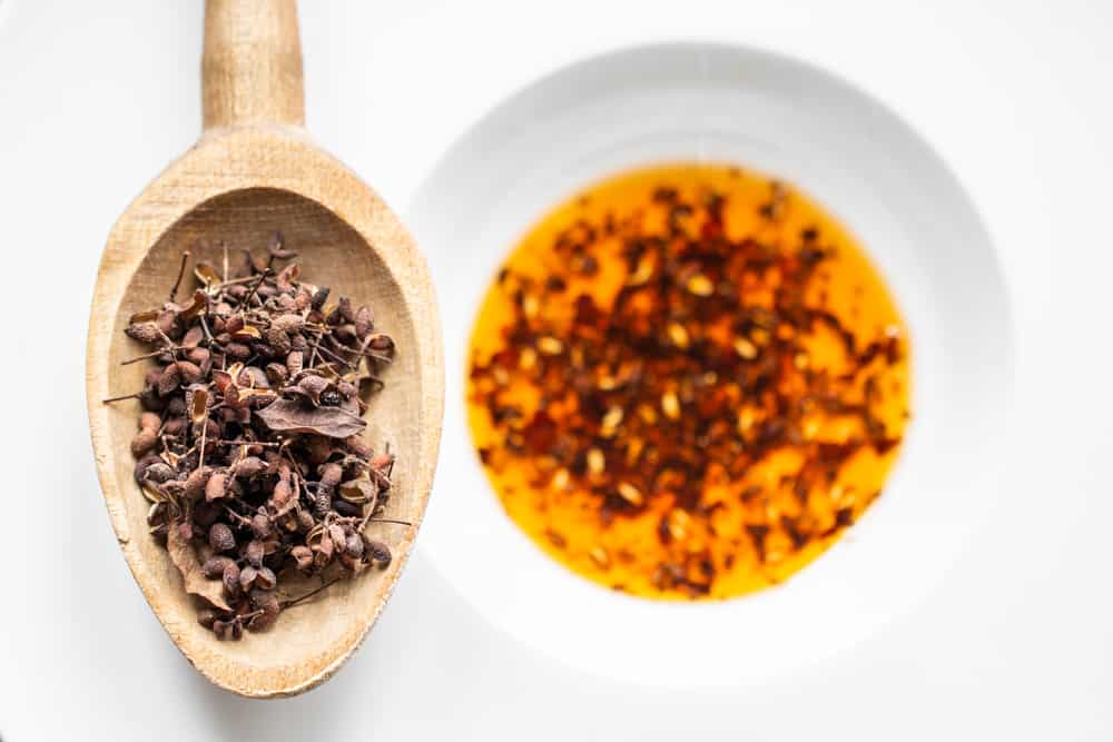 Foraged Szechuan peppercorn chili oil with a spoon of dried prickly ash berries 