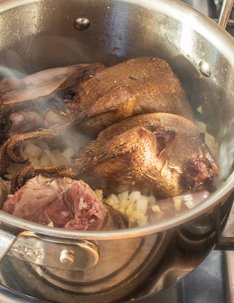 Cooking smoked pigeons with young venison for Brunswick stew 