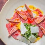 Beef carpaccio with beefsteak mushrooms, acorn oil, parmesan and shaved sochan