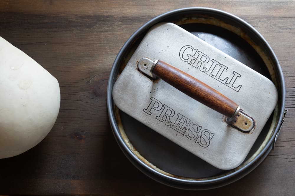 Pressing squash and puffball mushroom torte