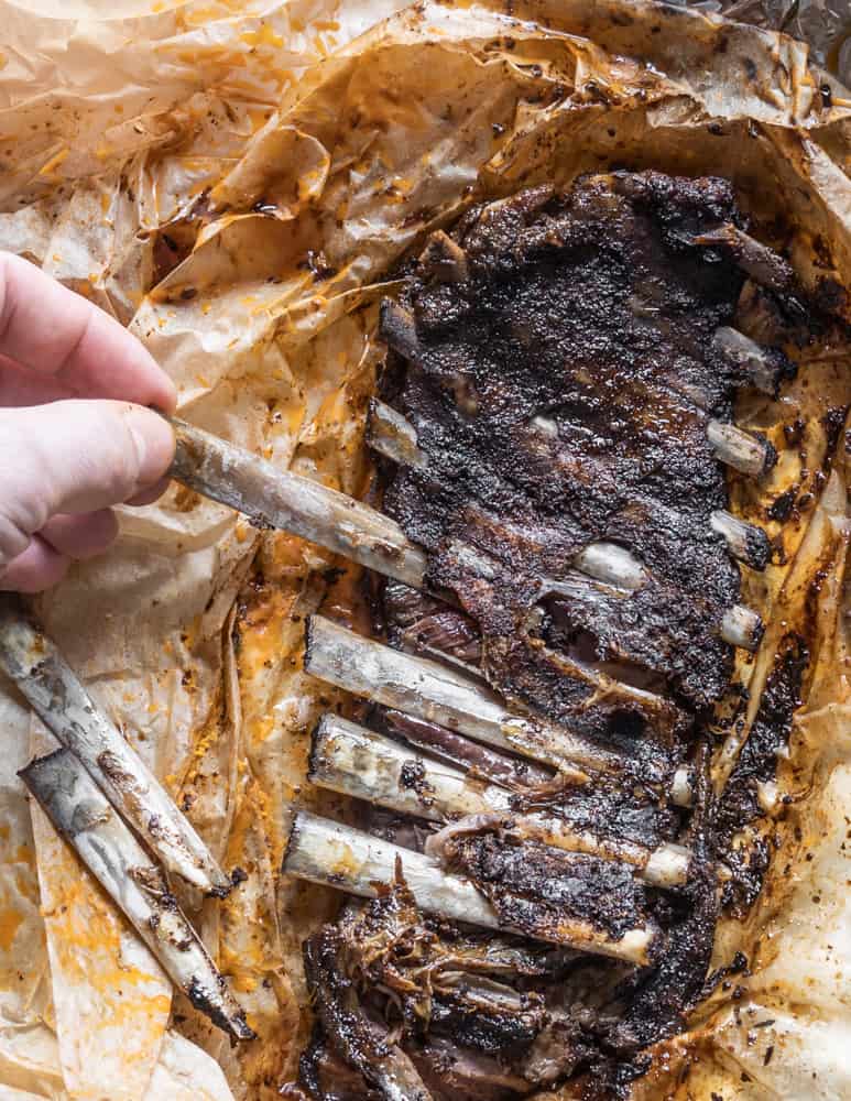 Removing the bones from cooked venison ribs