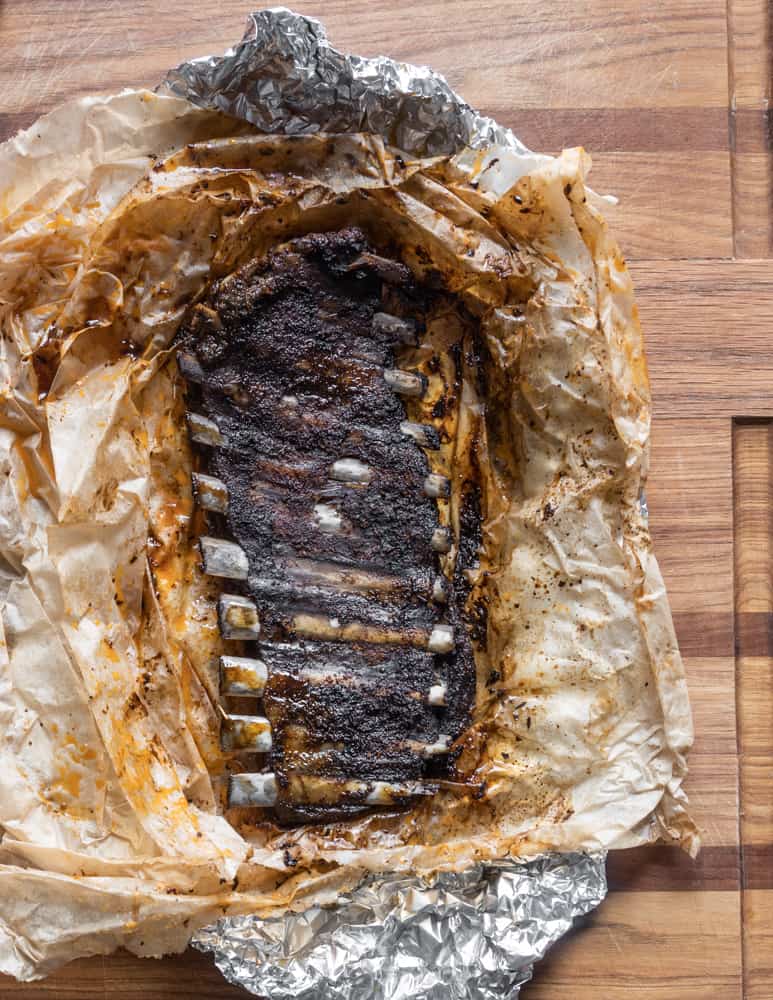 Removing the bones from cooked venison ribs