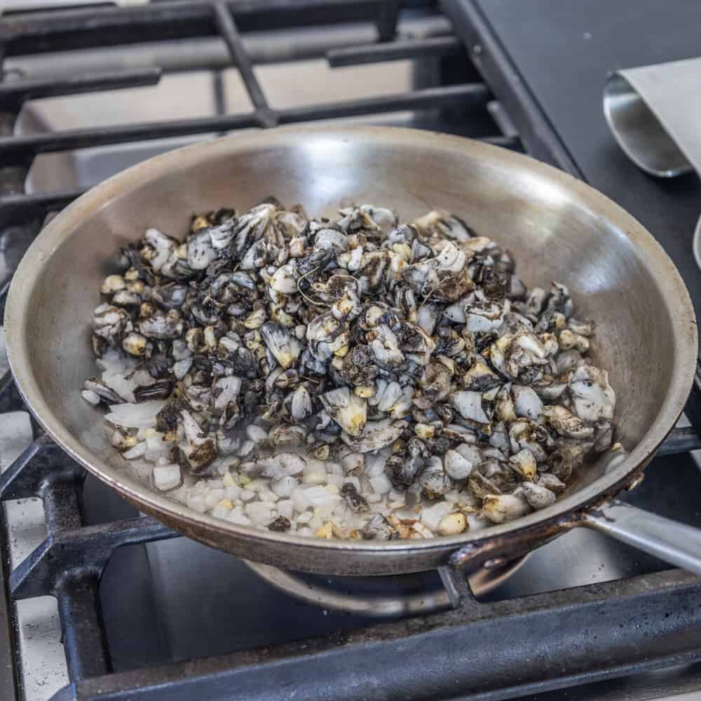 cooking huitlacoche or corn mushrooms in a pan