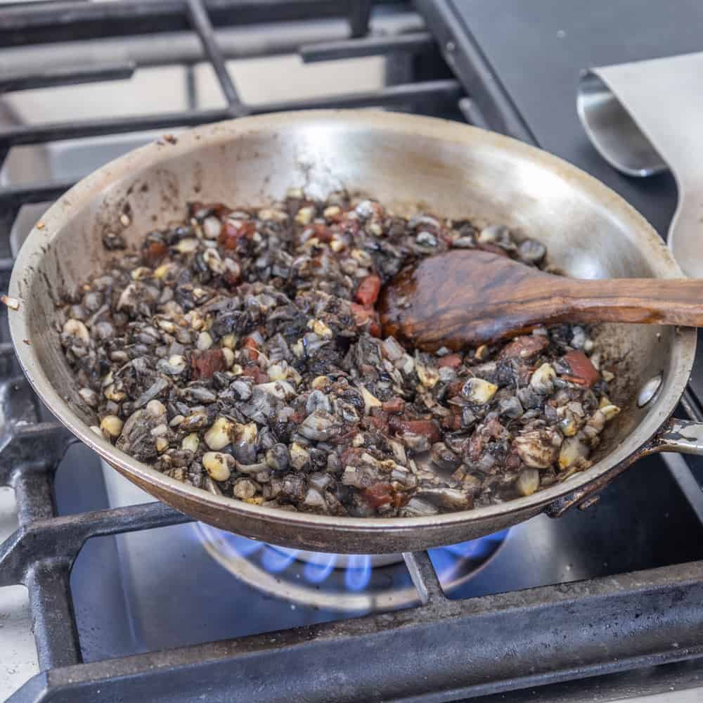 cooking huitlacoche in a pan