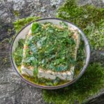 marinated feta cheese with herbs on a plate