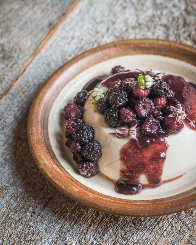 Sweet woodruff panna cotta with blackcap raspberries