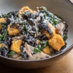 Sweet potato or squash gnocchi with black trumpet ragu, spinach