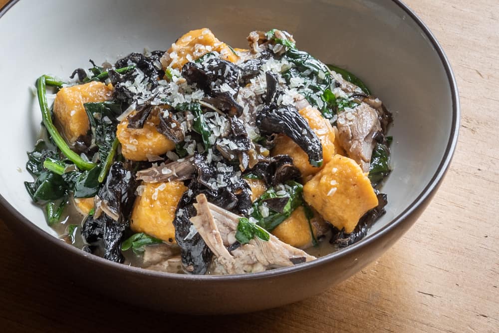 Sweet potato or squash gnocchi with black trumpet ragu, rabbit confit and spinach