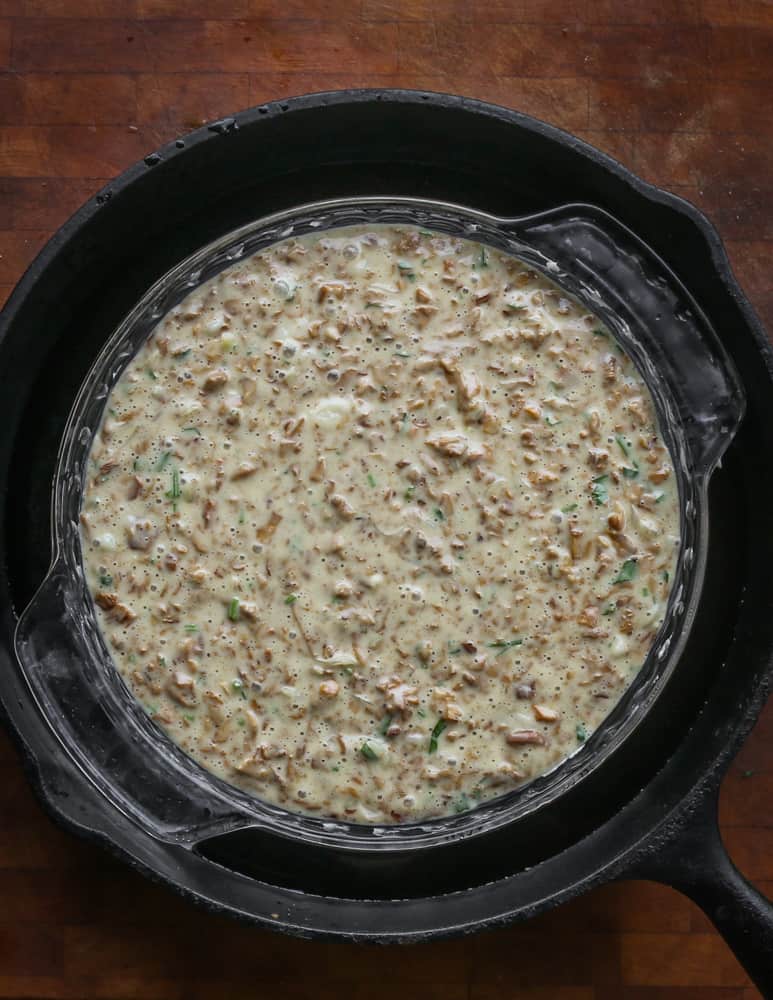 Raw chanterelle pudding in a pie pan ready to go in the oven 