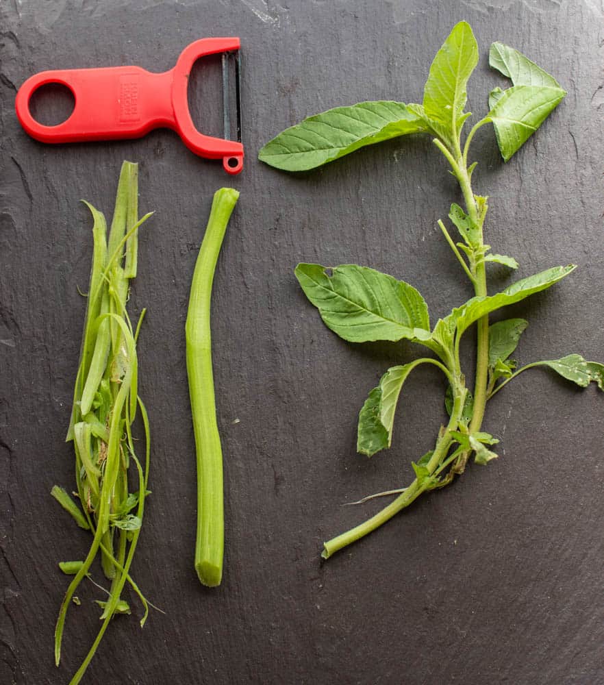 Peeling Amaranth stems before cooking 