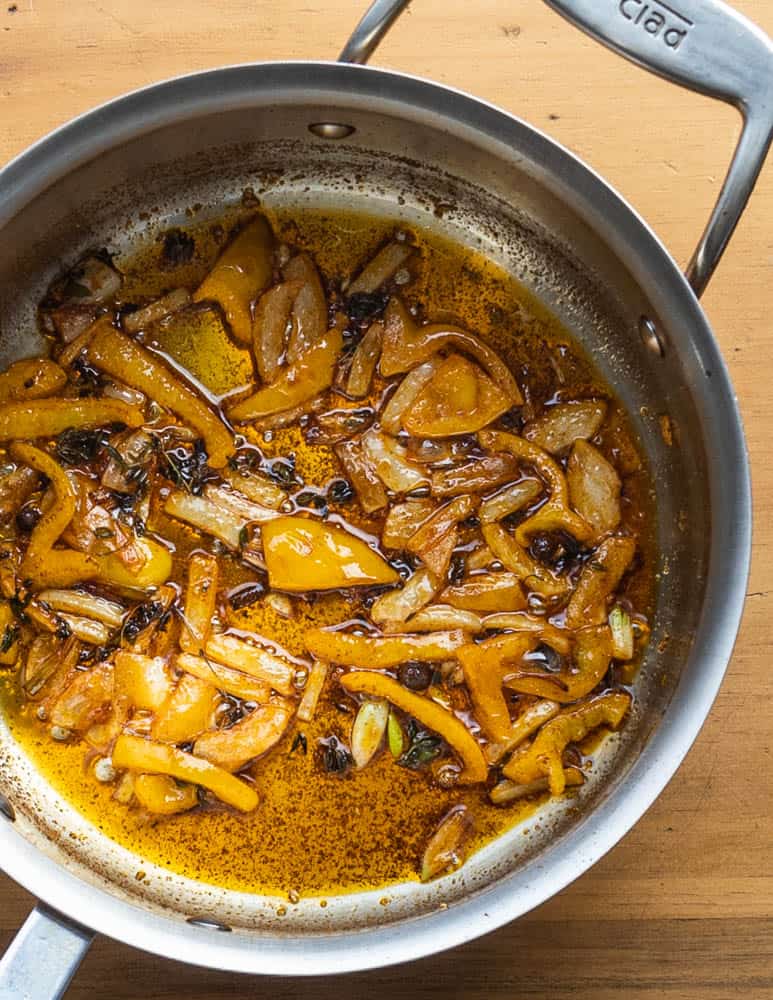 Cooking peppers and onions for callaloo 