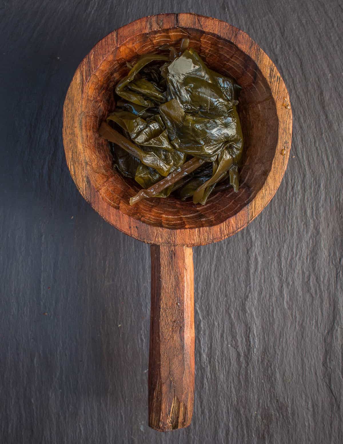 Fermented ramp leaves (Черемша) in a wooden ladle 