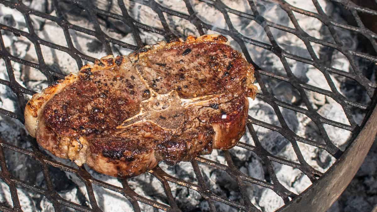 A Barnsley lamb chop cooking on the grill