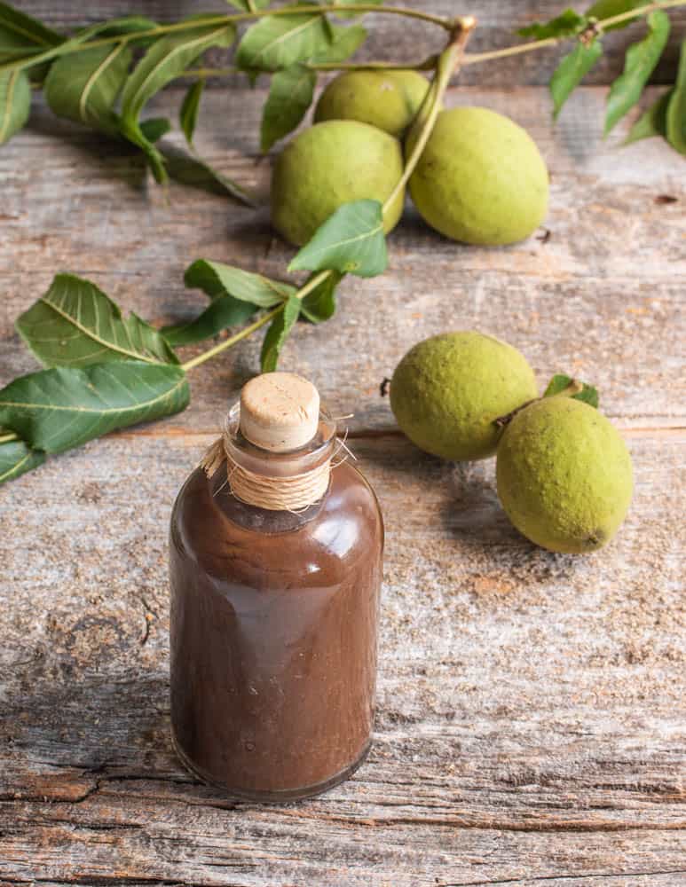 a bottle of walnut ketchup with green walnuts 