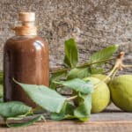 a bottle of walnut ketchup with green walnuts