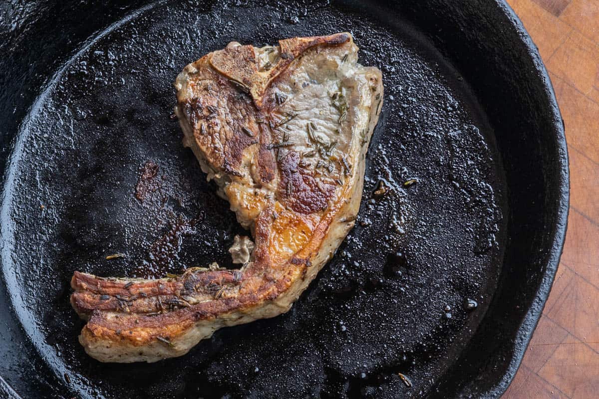 Goat Chops with tail cooking in a pan 