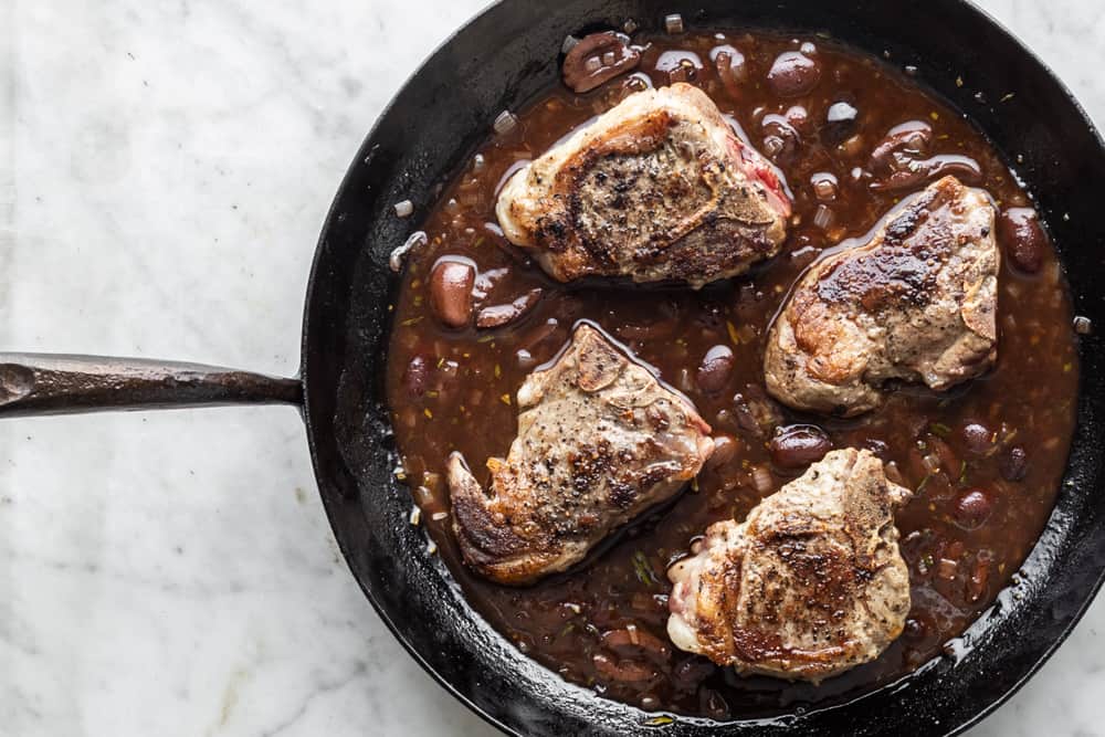 Goat loing chops with red wine, rosemary and olives in a Kehoe carbon pan