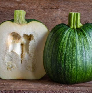 Green unripe pumpkin cut in half