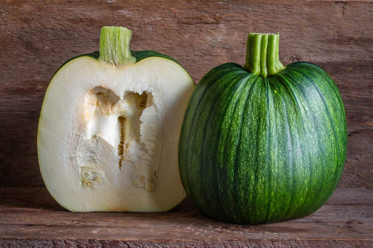 Green unripe pumpkin cut in half 