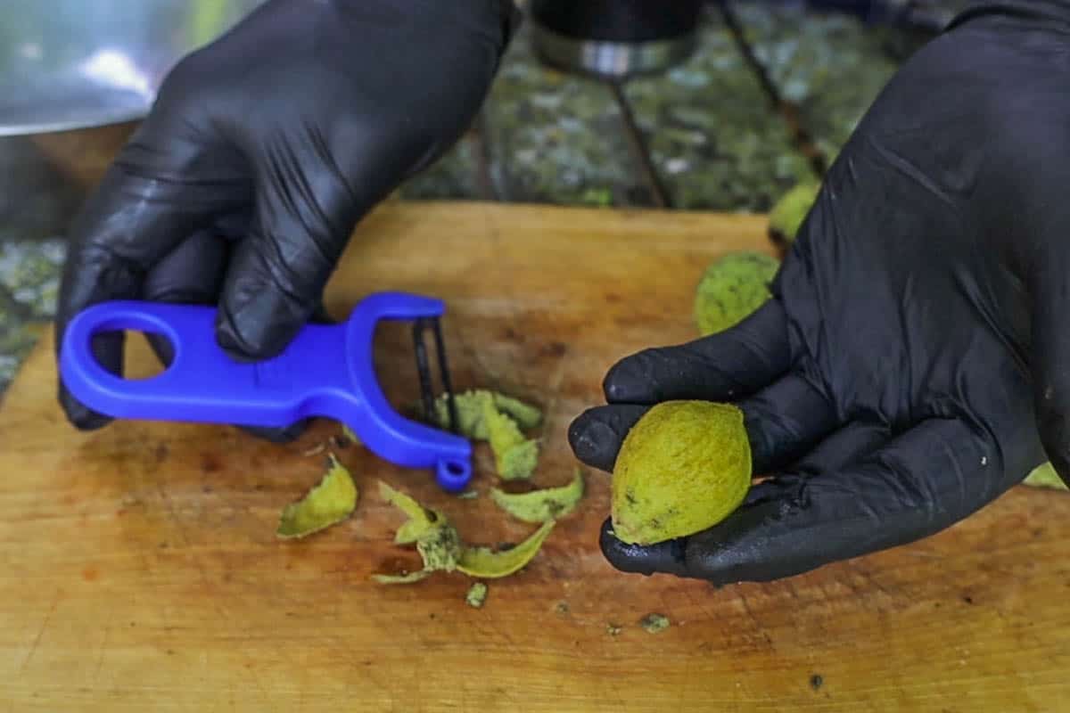 Peeling green walnuts