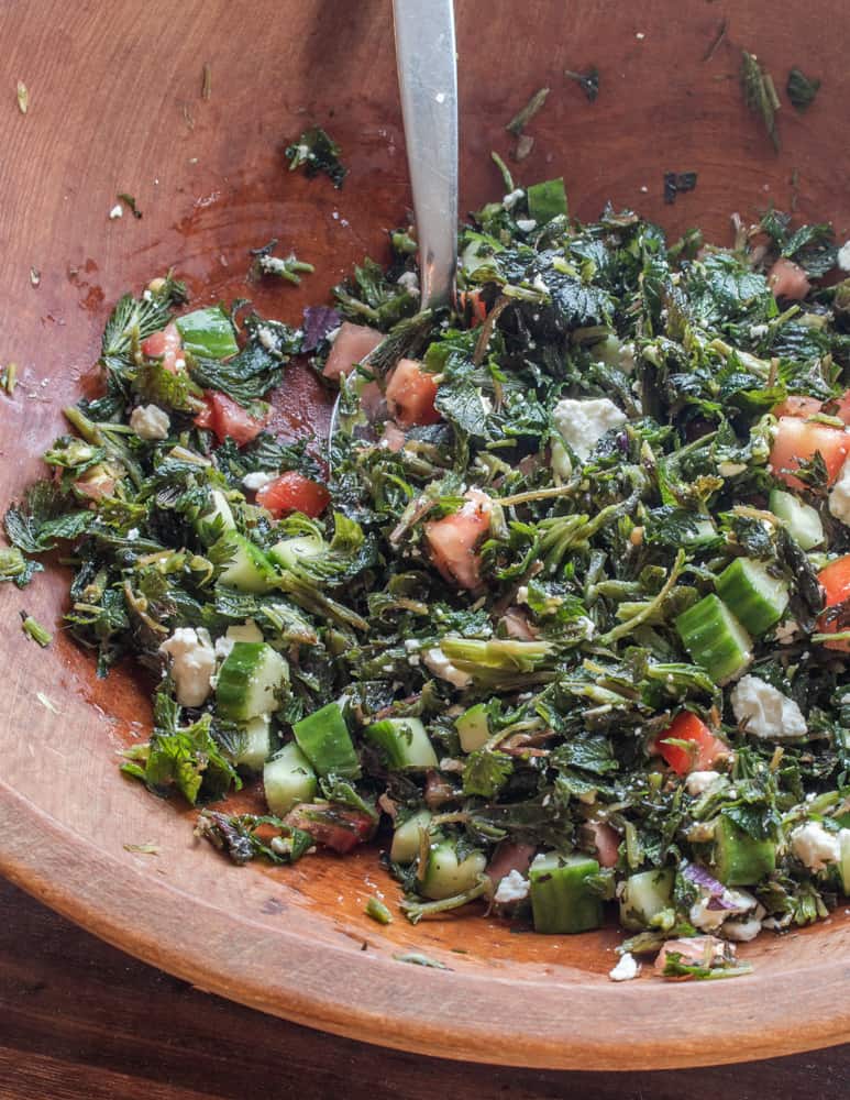 mixing chopped nettles for turkish Isirgan salatasi salad