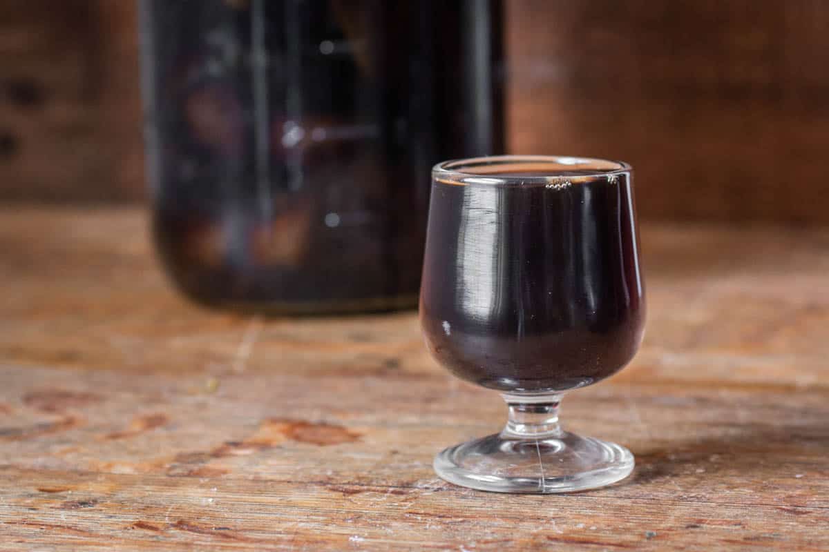 Black walnut wine or vin de noix in a glass