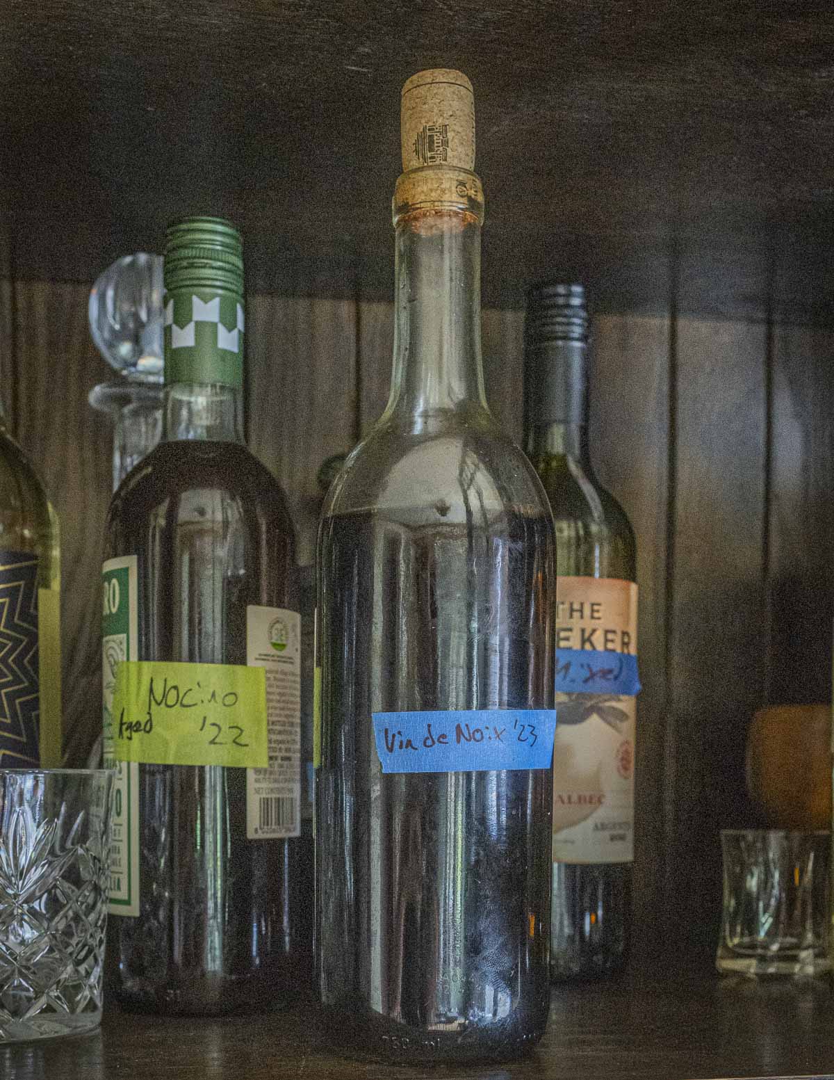 Aging black walnut wine in a cupboard. 