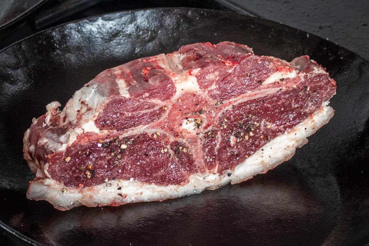 searing the fat on a lamb barnsley chop