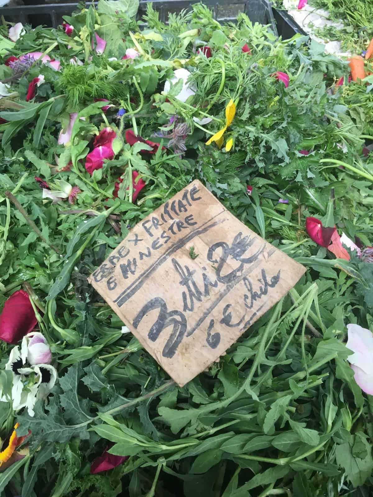 Foraged greens or erbe selvatiche at a farmers market in Torino, Italy