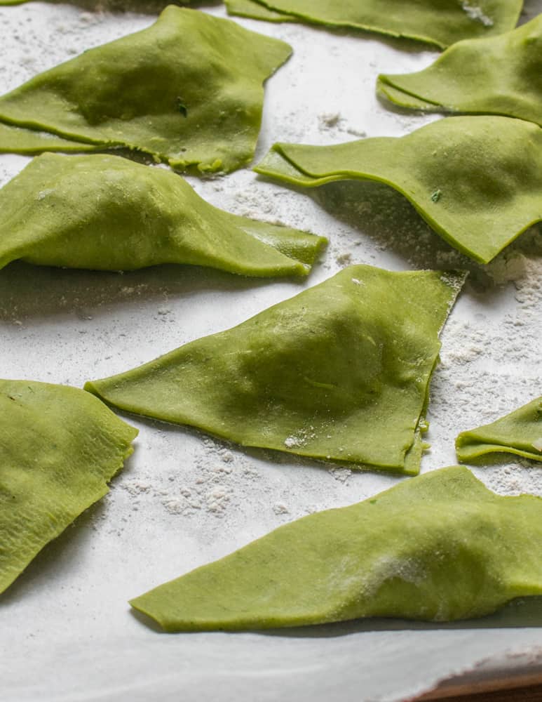 Green, triangular ravioli made with wild edible plants