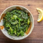 Ligurian preboggion with garlic, olive oil and lemon in a stoneware bowl