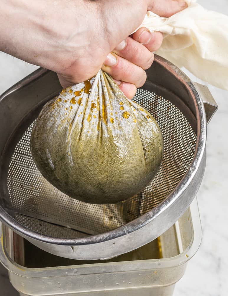 Straining ramp leaf garum through muslin