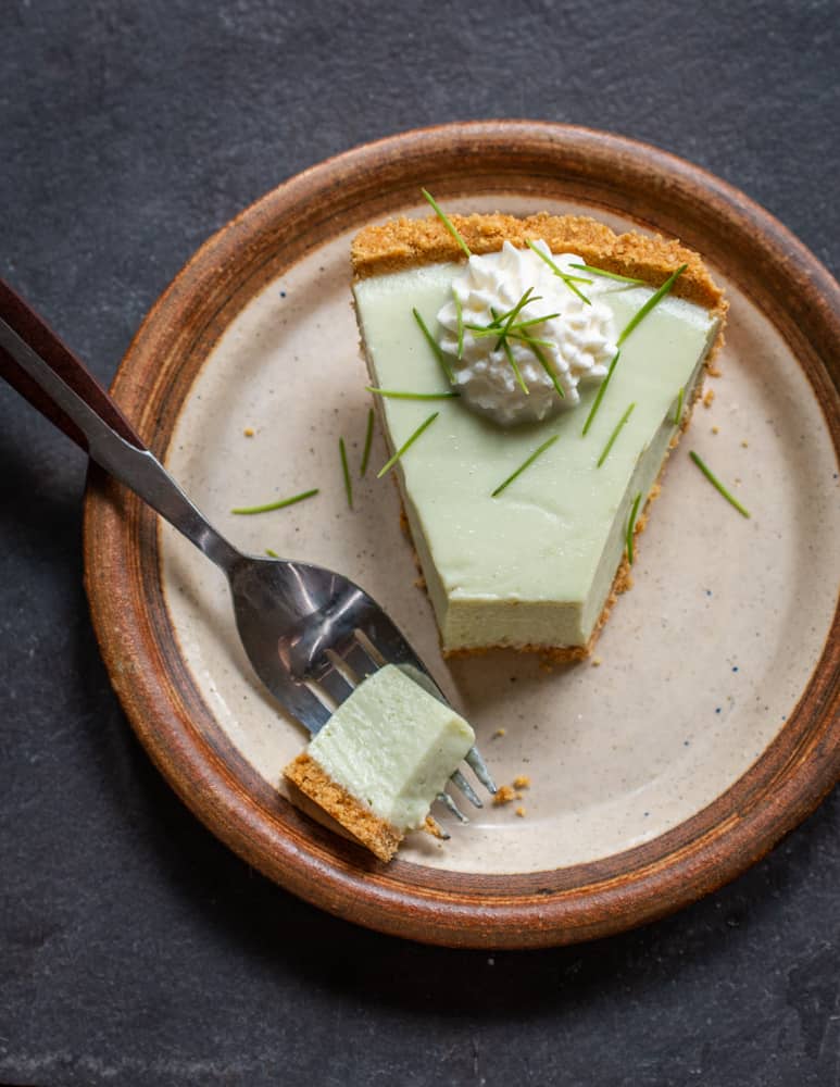 a slice of spruce tip key lime pie on a plate