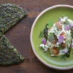 Wild spinach cake with bacon, ramp sauce and wild flowers